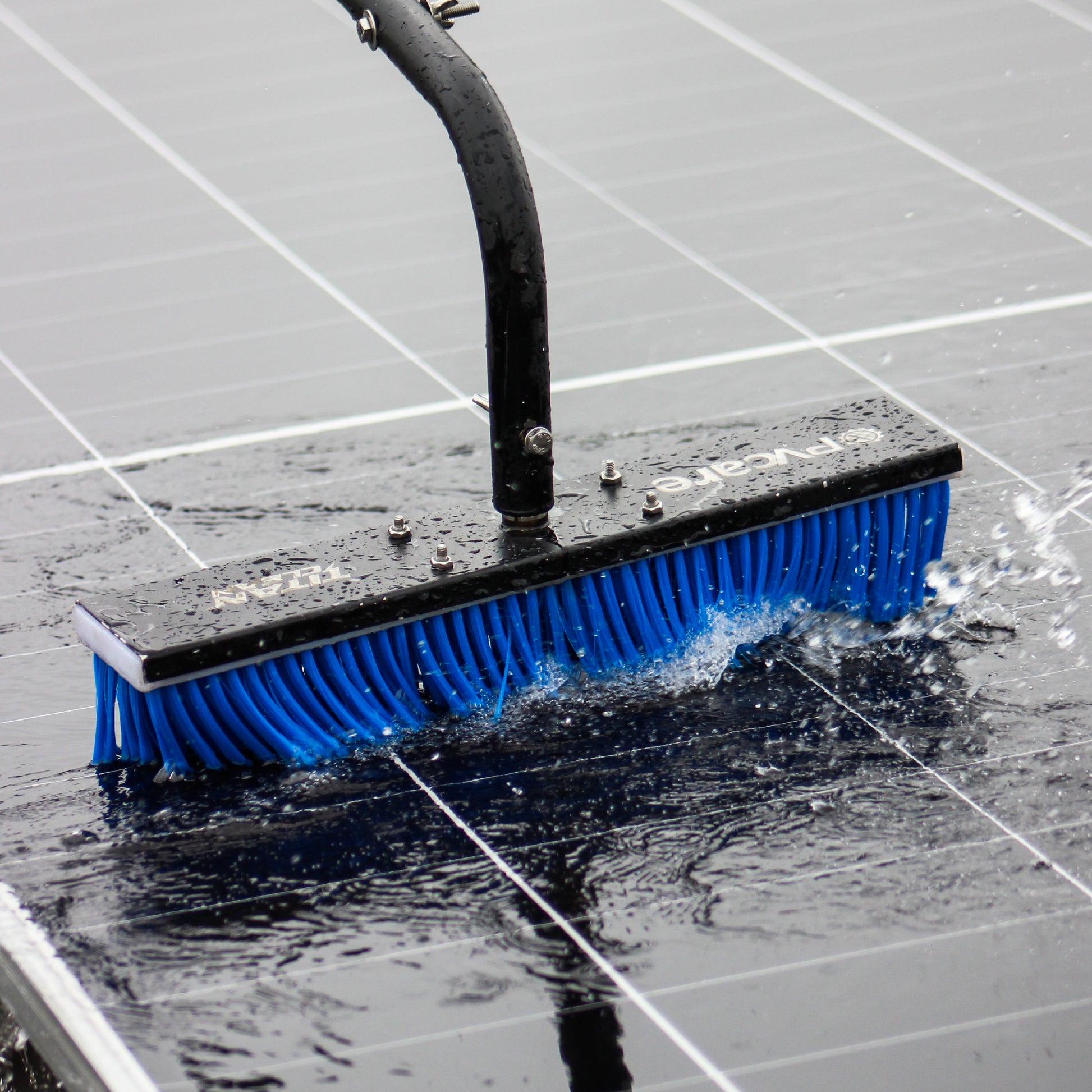 Soalr cleaning brush with blue bristles cleaning a tiled floor