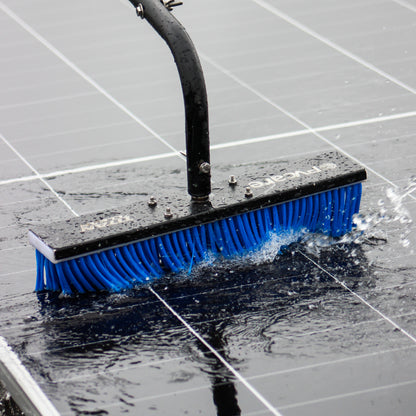 Soalr cleaning brush with blue bristles cleaning a tiled floor