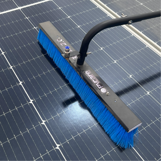 Cleaning brush with blue bristles on a solar panel