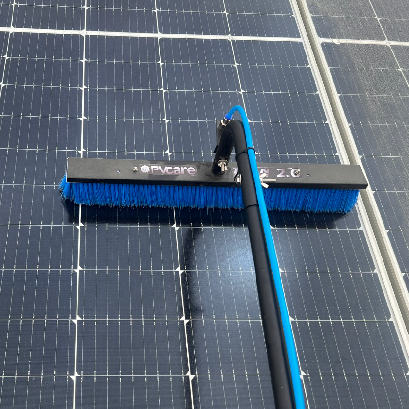 Solar panel cleaning brush on a solar panel