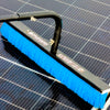 Solar Cleaning brush with blue bristles cleaning a solar panel